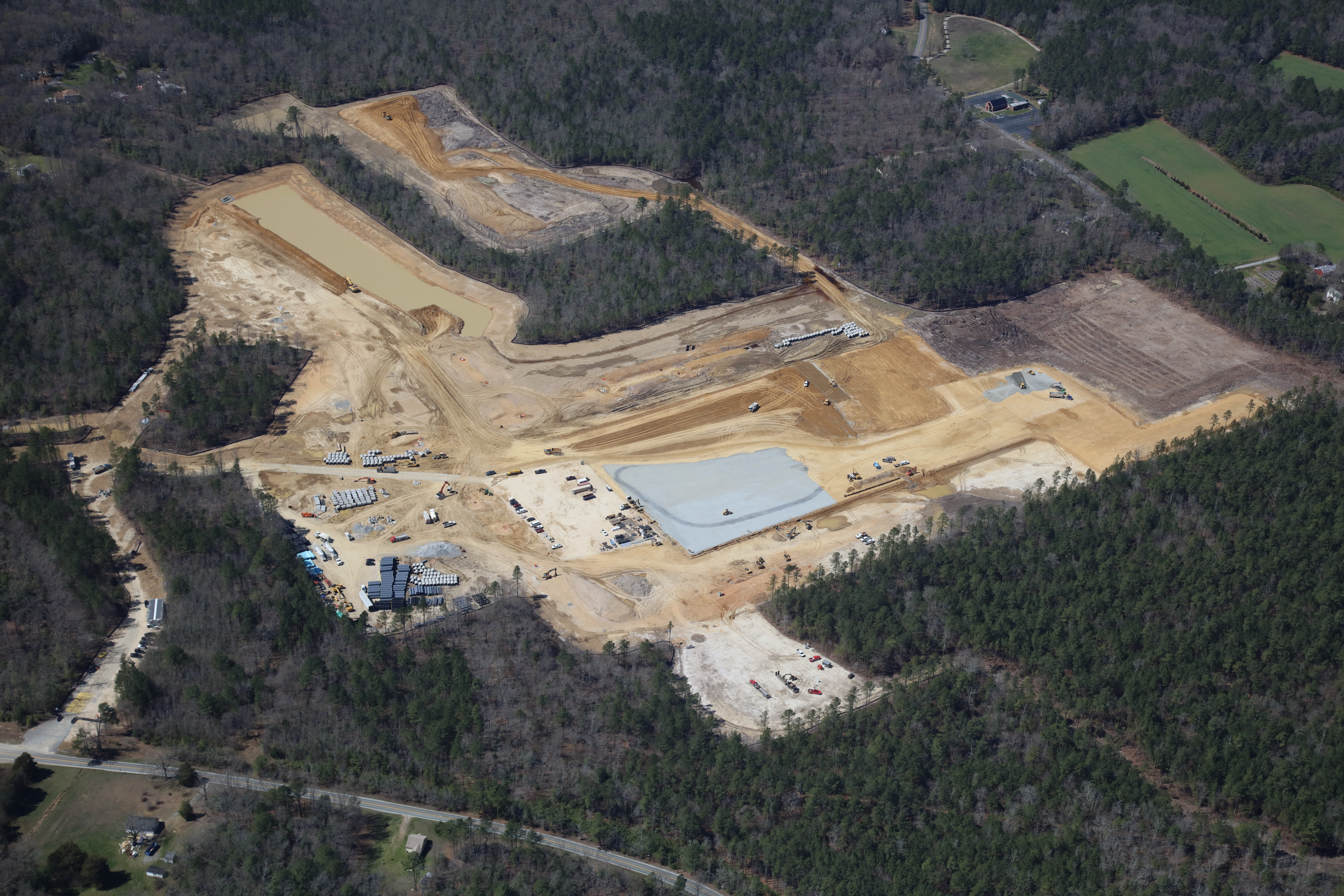 Aerial photo of construction site that will house a large distribution center; foundation visible.