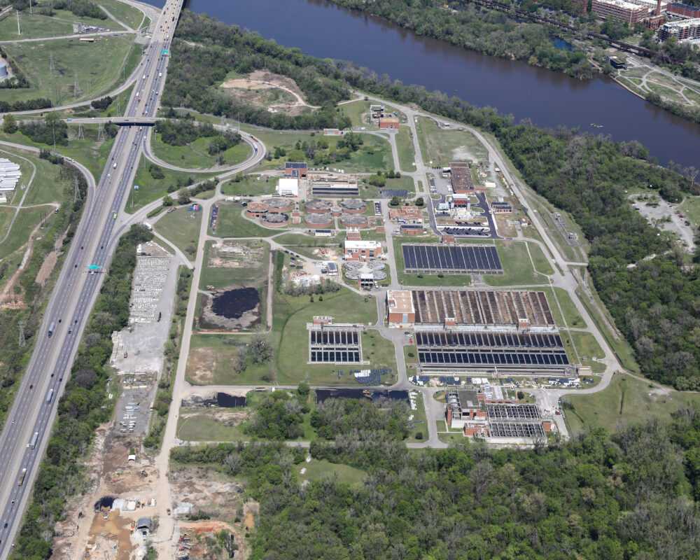 Aerial view of modern office park, greenery, and parking lots.