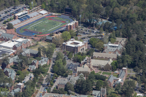 Aerial view: campus, stadium, buildings, walkways, and green spaces.