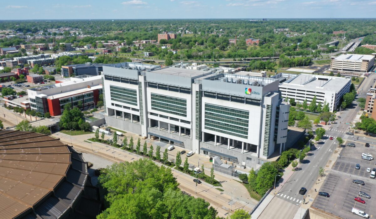 Aerial view of a modern hospital, parking lots, and city.