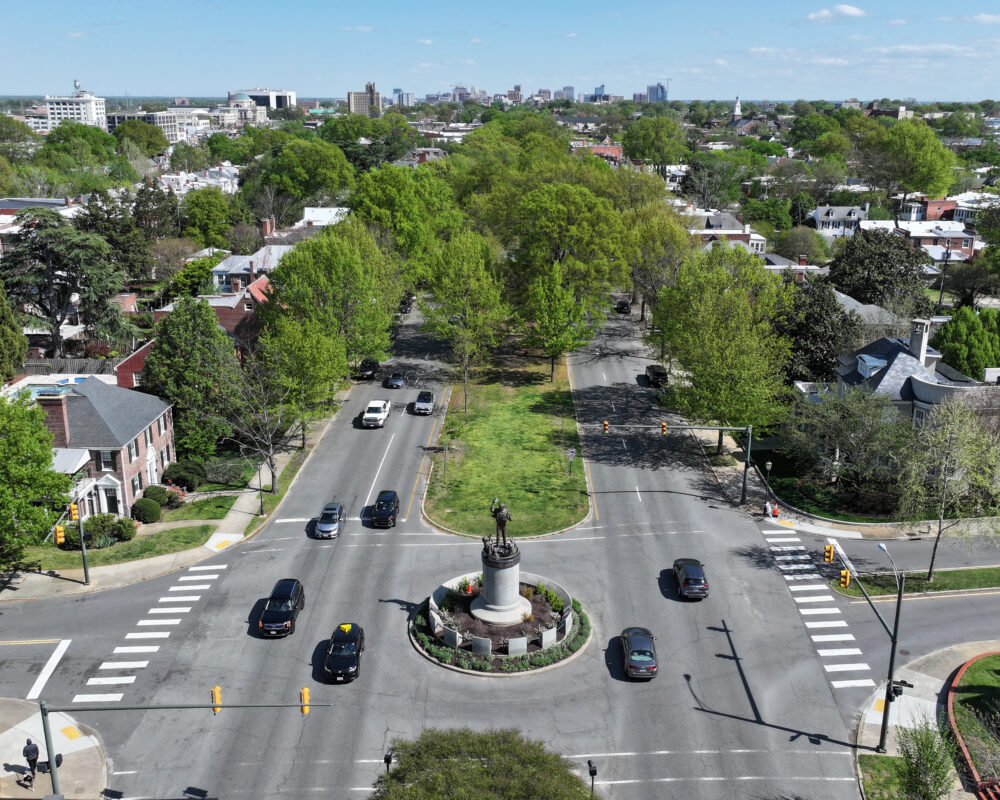 Aerial view of modern office park, greenery, and parking lots.