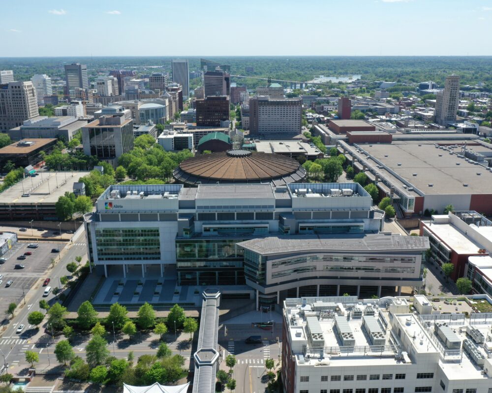 Aerial view of modern office park, greenery, and parking lots.